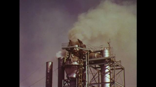 UNITED STATES: 1960s: smog and smoke above factory. High energy scrubbers at car manufacture plant. 