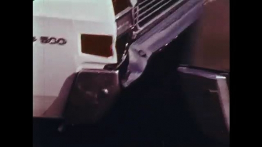 UNITED STATES: 1970s: cars collide. Drivers point at damage from crash. 