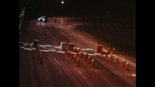 UNITED STATES: 1970s: car drives through cones on obstacle course