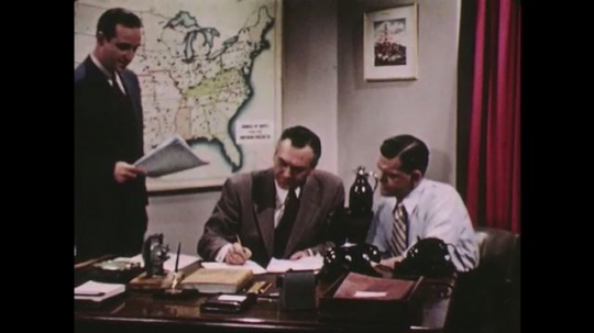 UNITED STATES: 1950s: purchasing department men in meeting. 