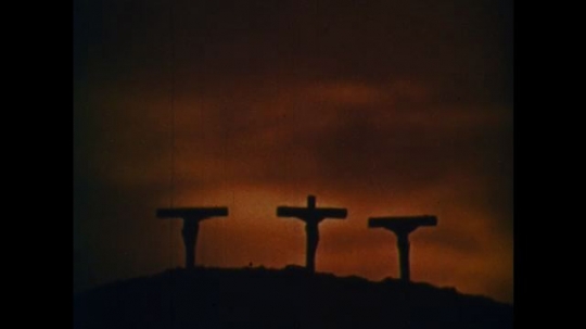 UNITED STATES: 1950s: three crosses on hill in sun. 