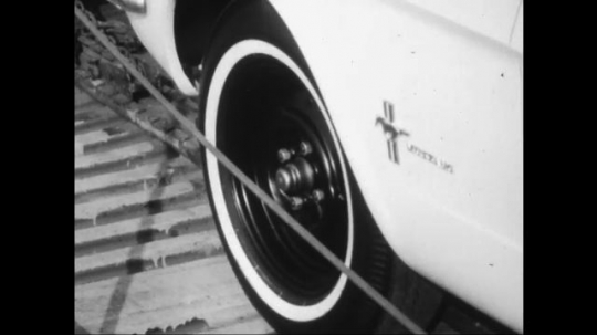 UNITED STATES: 1960s: close up of cars on top of transportation ramp