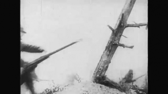 UNITED STATES: 1910s: soldiers run past tree. Soldiers hit and collapses. Soldier fires bullets. 
