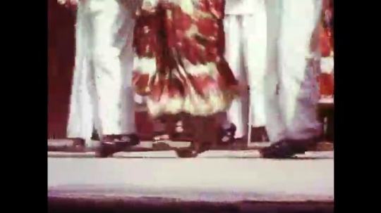 UNITED STATES: 1960s: ladies and men dance. Traditional dancing. Girl plays outside at festival