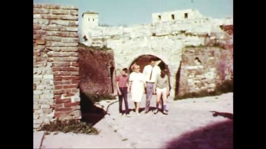 UNITED STATES: 1960s: family enjoy walk around ancient building.
