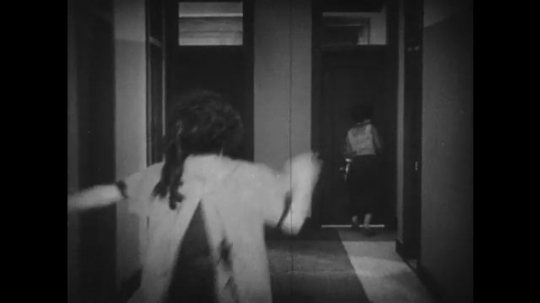 1920s: women run down hallway and exit through doors. lion jumps up on transom and roars at men and women in office. woman grabs lion tail and exits. woman slids across floor. lion leaps around room. 
