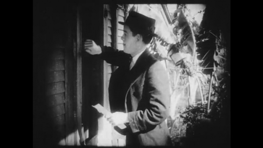 1910s: Man knocks on door, woman answers and let him in. He shows her a letter stating that his cartoons have been accepted.