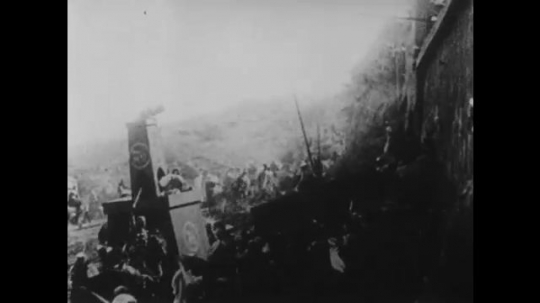 1910s: UNITED STATES: men attack city walls, Man sits on throne and waits. Soldiers fight with rocks and shields. Men with swords, Man pushes servant away