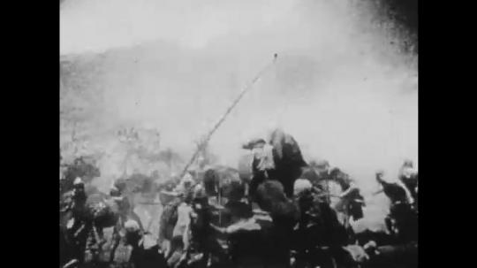 1910s: UNITED STATES: men in battle by well. Men on horses. Soldiers fight with swords. Soldiers rush across field