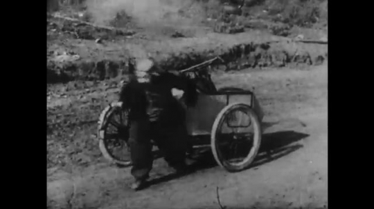 1910s: man with mustache fires gun, chases off men, abducts woman and forces her back into motorcycle sidecar. three men in police uniforms run down dirt road. man in cowboy hat rides horse.