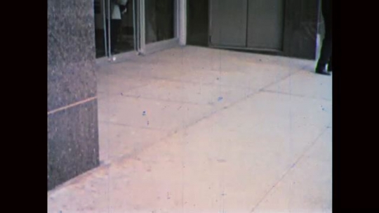 1960s: UNITED STATES: boy leaves bank building. Boy looks at cheque. Seagull flies in sky. 