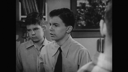 1950s: Boys talk. Tools on display