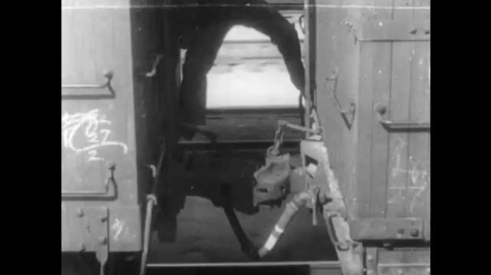 1910s: Man climbs in between train cars, pulls lever on connecting bit. He then climbs to the top and runs with a woman to the front of the train. 