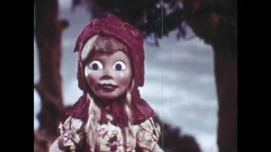 1940s: Animation of Little Red Riding Hood, she looks around in the forest, smiles, remembers her mother?? advice. Little Red Riding Hood walks off the path towards a river and looks at flowers.