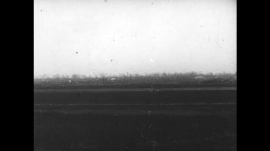 1930s: Flatlands with a few houses. Flatlands with a few fences, wind blows. 