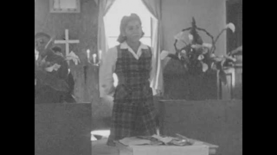 1930s: Teenage Paiute girls speaks to congregation. Blind Paiute Bob Dale plays the violin. New members of congregation signs the membership book. 