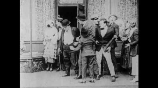 1910s: Mob sees couple exit diner. Man kicks mob. Mob falls to ground. Women leave unconscious man at diner. Man drops girl off with mother. Boss and man confront man. Woman and man talk.
