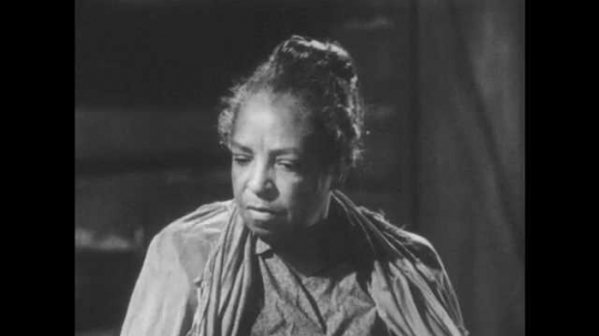 1940s: African American woman speaks. Boy responds. Slave woman speaks and shakes head.