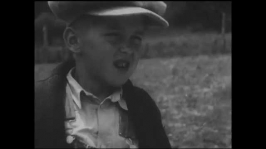 1930s: UNITED STATES: boy speaks. Close up of boy