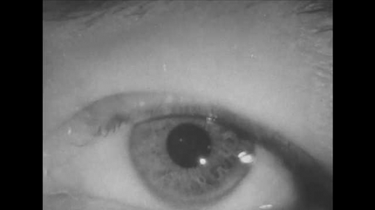 1940s: Human eye pupil dilates. Man walks through room, turns off light.