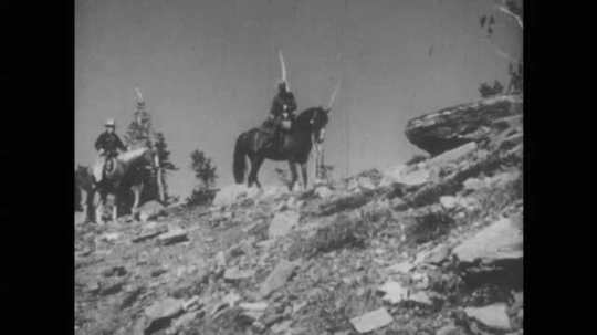 1940s: People ride horses on mountain. Mountain goats grazing. 