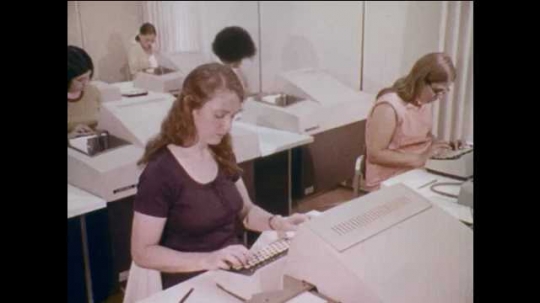 1970s-united-states-workers-in-office-key-punch-operator-punch-tape